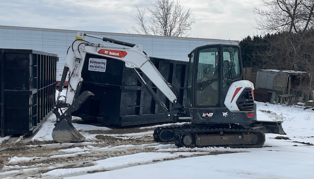 backhoe at dewetering bobcat services & bin rental